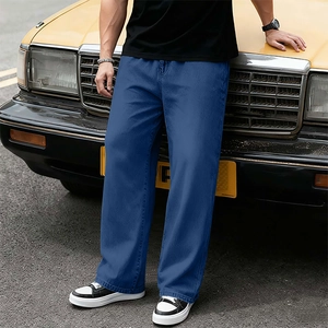Close-up of premium dark blue denim trousers featuring a relaxed straight leg fit