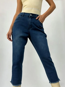 Detail showing high-waisted dark blue stretch denim jeans with stylish raw frayed hems