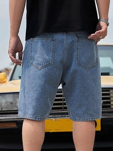Men's casual loose straight denim shorts in light blue, shown from a back view outdoors