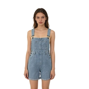 Close-up of light blue denim overalls showing chest pocket and metal buckle details
