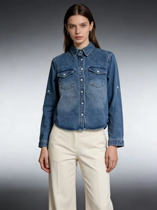 Women's casual loose denim shirt with long sleeves and flap chest pockets in mid-blue wash