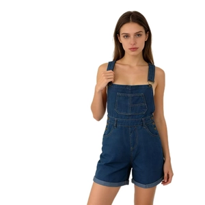 Detail view of dark blue denim overalls featuring square front pocket and metallic buttons