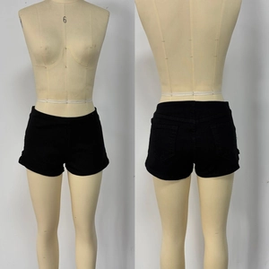 Front and back view of black slim-fit denim shorts with invisible side zipper