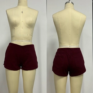 Detail view of high-waist wine red denim shorts featuring twin back pockets on a mannequin