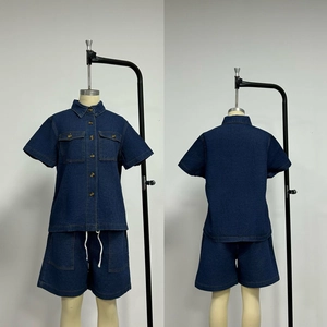 Detail of dark blue denim set with short sleeve button-up shirt and drawstring shorts