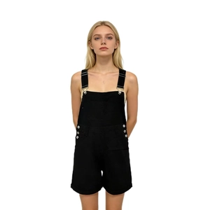 Close-up of black denim dungaree shorts showing metal buckles and side button details