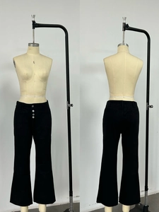 Detail view of high waist black flare jeans with triple button closure and front pockets