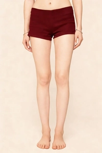 Detail of high-waist wine red slim stretch shorts showing stitching and fabric texture
