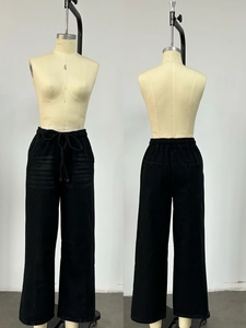 Front and back view of black loose-fit drawstring wide-leg denim pants on a mannequin