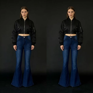 Close-up of high-waist washed flared jeans and black satin bomber jacket set