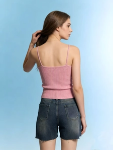 Pink ribbed camisole paired with dark blue frayed denim shorts for a stylish summer look