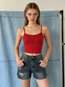 Detail of red and white striped crop top with blue denim shorts and frayed hem design