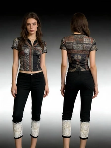 Detail view of black cropped jeans featuring exquisite white floral lace patchwork at cuffs