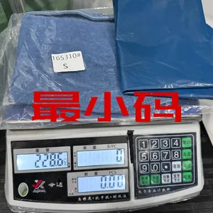 Close-up of a blue denim vest in size S being weighed on a digital scale for accuracy