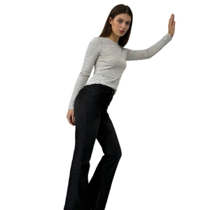Side view of black high waisted flare jeans paired with a striped long sleeve t-shirt