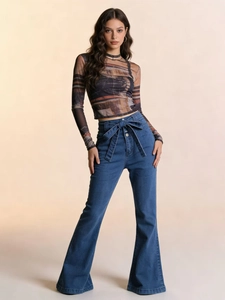 Detail of high waisted flare jeans with a matching denim tie belt and wide leg cut