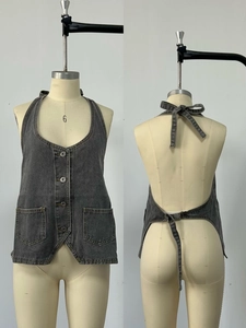 Front and back views of a vintage dark grey washed denim halter vest with metal buttons