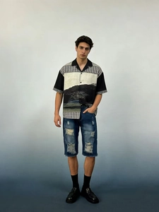 Détail du short en jean pour homme avec design déchiré et finition délavée vintage