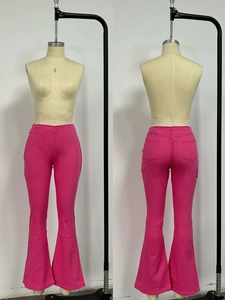 Detail view of hot pink flare jeans with slimming fit and rear pockets on mannequin