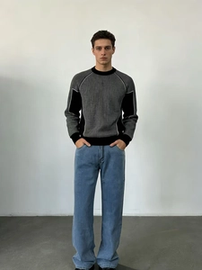 Détail du pull en maille bicolore gris et noir avec poignets et col côtelés