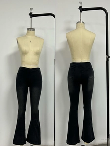 Front and back view of women's high waisted flared black denim jeans with retro wash finish