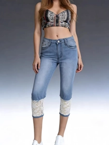 Women's light blue straight cropped jeans with white lace floral hem detailing