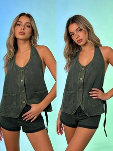Detail view of dark green denim halter vest with button-down front and lace-up back