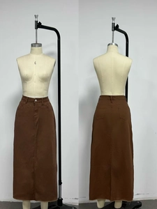 Detailed front and back view of a brown high waist denim maxi skirt with raw hem edge
