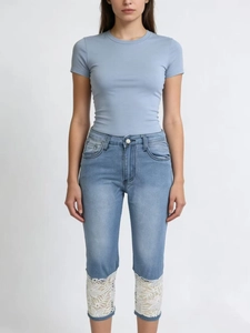 Women's light blue high waist straight jeans with white floral lace trim at the hem