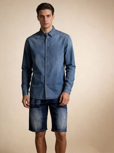 Front view of men's casual blue denim shirt and matching washed denim shorts on a model