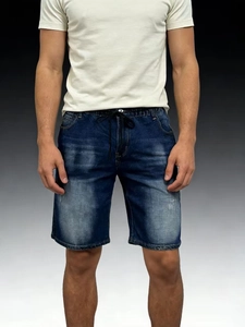 Close-up of men's blue denim shorts featuring elastic waist with black drawstring detail