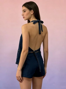Detail view of stylish dark blue denim halter neck top with open back and matching shorts