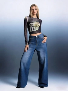 Detail shot of wide-leg blue jeans featuring high-waist fit and vintage drape style
