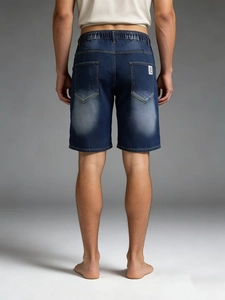 Men's deep blue denim shorts with elastic waist and back pockets in a classic five-point fit