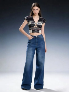 Detail of high waist wide leg jeans with vintage wash effect and cropped V-neck knit top