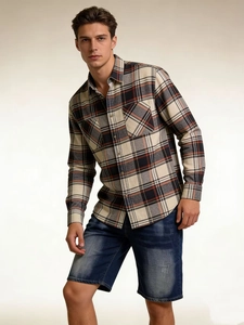Detailed view of red and black plaid flannel shirt with classic symmetrical chest pockets