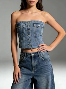 Detail shot of a dark blue washed denim tube top with metal buttons and chest pockets