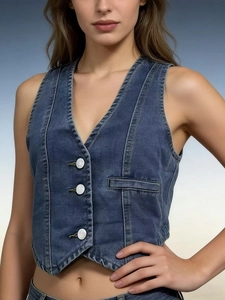 Close-up of slim fit blue denim vest with white buttons and V-neck for women