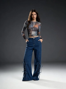 Detail of high-waist wide-leg jeans featuring unique side lace-up cutout leg hems