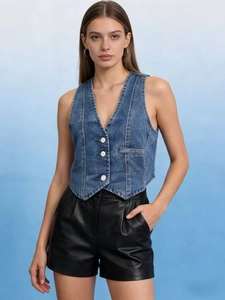 Close-up of casual women's denim vest featuring V-neck and white buttons on blue denim