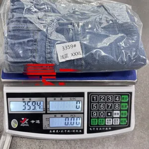 Weight check for denim shorts size XXXL showing 359.4g on a digital scale in factory