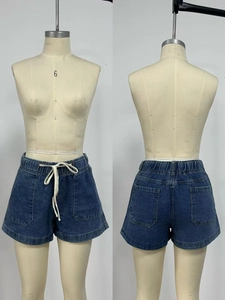 Front and back detail of blue denim shorts with elastic waist, drawstring, and four pockets