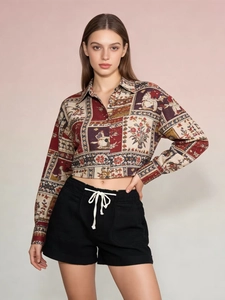 Detail of high-waisted black drawstring shorts paired with a retro patterned long sleeve crop top