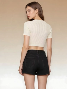 Detail view of high-waist black denim shorts with elastic drawstring waist and back pocket