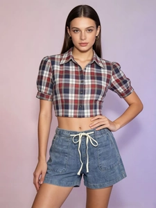 Detail of red and blue plaid cropped blouse with light wash drawstring denim shorts