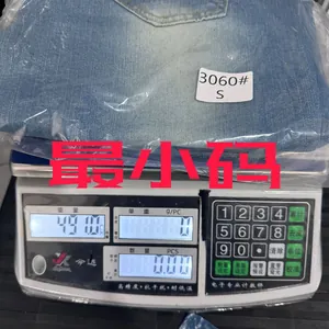 Detailed view of light blue flare jeans in packaging showing S size on a digital scale