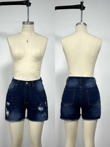 Front and back detail of distressed high-waisted denim shorts with frayed hems and cat whisker wash