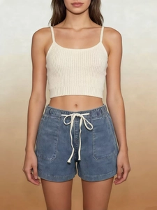 Detail view of denim shorts with elastic drawstring waist and large front pockets