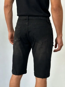 Rear view detail of men's distressed grey denim shorts with back pockets and frayed hem