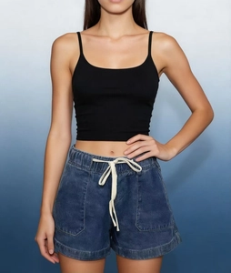 Detail of blue denim shorts featuring elastic drawstring waist and large utility pockets